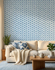 Worn Chevron blue geometric peel and stick wallpaper in a warm and inviting living room