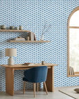 Worn Chevron blue geometric peel and stick wallpaper as a feature wall in a bright home office