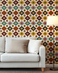 Southwestern geometric wallpaper with repeating diamond motifs in warm earth tones including rust red, mustard yellow, sage green, teal, charcoal, and ivory.