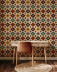Southwestern geometric wallpaper with repeating diamond motifs in warm earth tones including rust red, mustard yellow, sage green, teal, charcoal, and ivory.