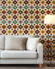 A decorative wall paper in a Southwestern style, utilizing warm desert hues: rust red, mustard yellow, sage green, teal, charcoal, and ivory. The design features a continuous geometric diamond motif.