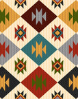 A palette of ivory, charcoal, teal, sage green, mustard yellow, and rust red defines this Southwestern-style wallpaper featuring continuous, repeating geometric diamond patterns