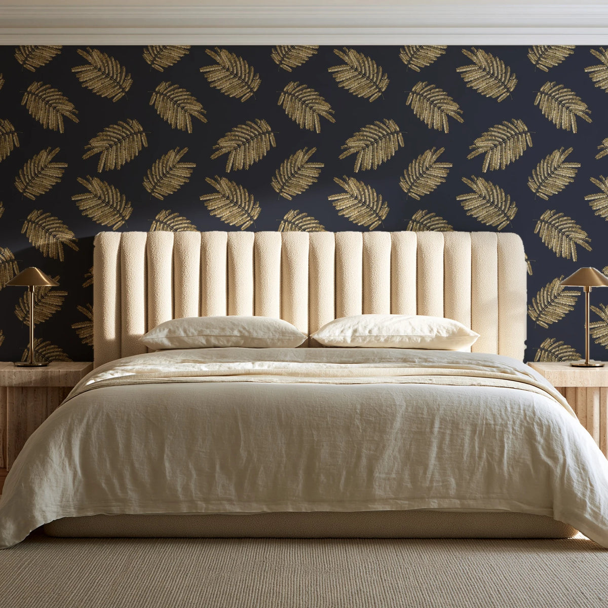 Acacia Scatter Black Gold dainty leaf wallpaper behind a channel-tufted bed in a calm primary bedroom
