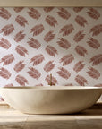 Acacia Scatter Oxblood dainty leaf wallpaper creating ambiance in a serene spa bathroom