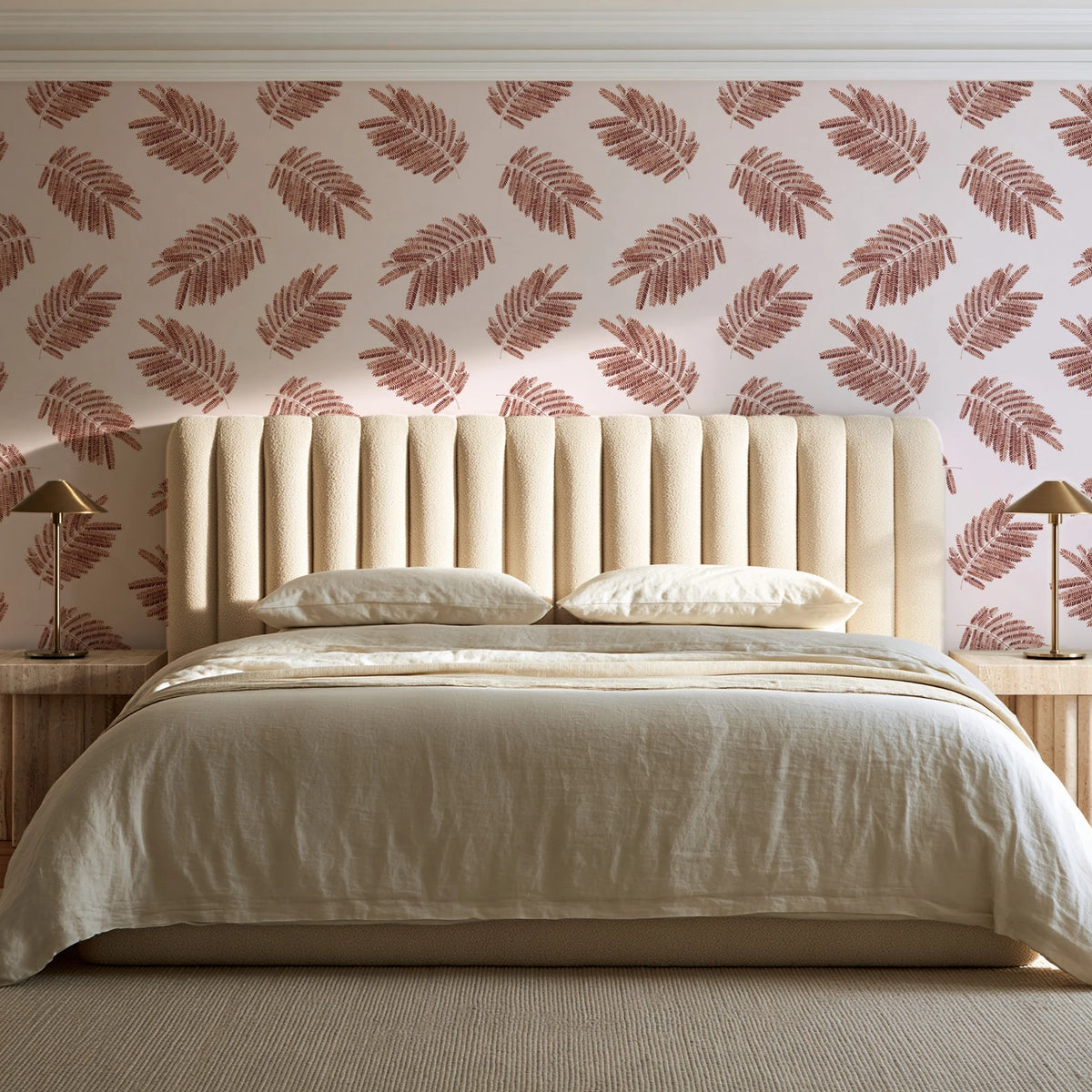 Acacia Scatter Oxblood dainty leaf wallpaper behind a channel-tufted bed in a calm primary bedroom