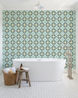 Andalusian Court Emerald encaustic tile wallpaper behind a freestanding tub in a bright coastal bathroom