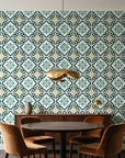 Andalusian Court Emerald encaustic tile wallpaper behind a walnut credenza and round table in an elegant dining room