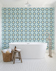Andalusian Court Peacock encaustic tile wallpaper behind a freestanding tub in a bright coastal bathroom