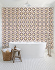Andalusian Court Terracotta encaustic tile wallpaper behind a freestanding tub in a bright coastal bathroom