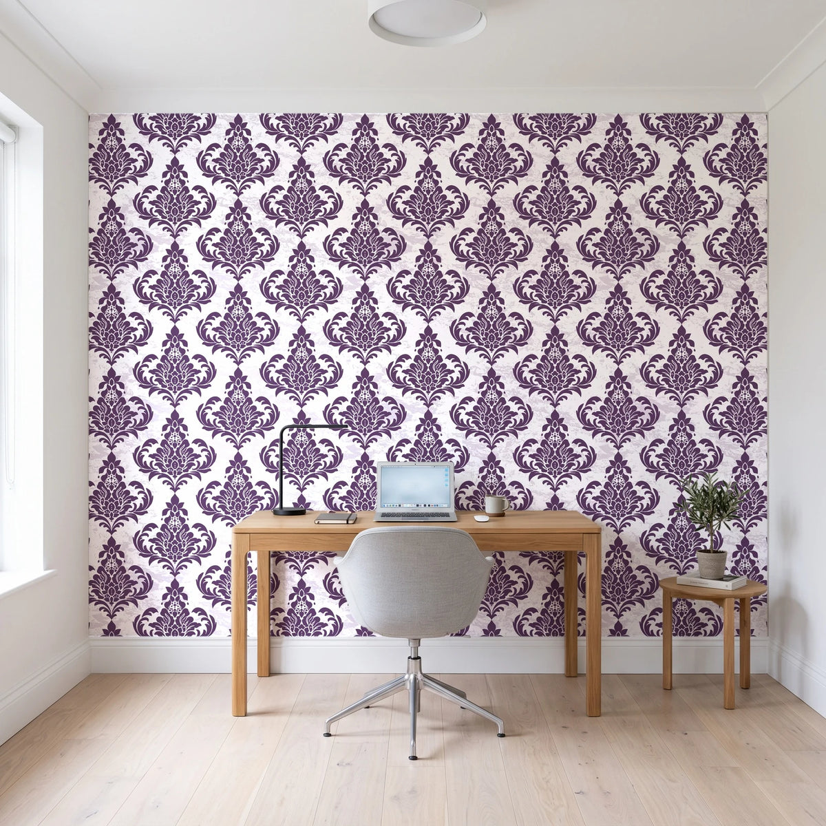 Antique Fern Mist Aubergine distressed damask wallpaper behind a modern oak desk in a bright home office
