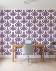 Antique Fern Mist Aubergine distressed damask wallpaper behind a modern oak desk in a bright home office