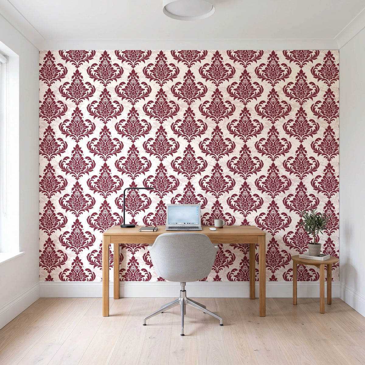 Antique Fern Mist Garnet distressed damask wallpaper behind a modern oak desk in a bright home office