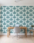 Antique Fern Mist Teal distressed damask wallpaper behind a modern oak desk in a bright home office