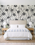 Apricot Tides Charcoal coastal seashell wallpaper behind a queen bed in a bright coastal bedroom