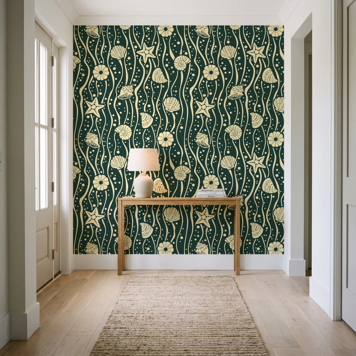 Apricot Tides Forest coastal seashell wallpaper behind a console table in a light entry hallway