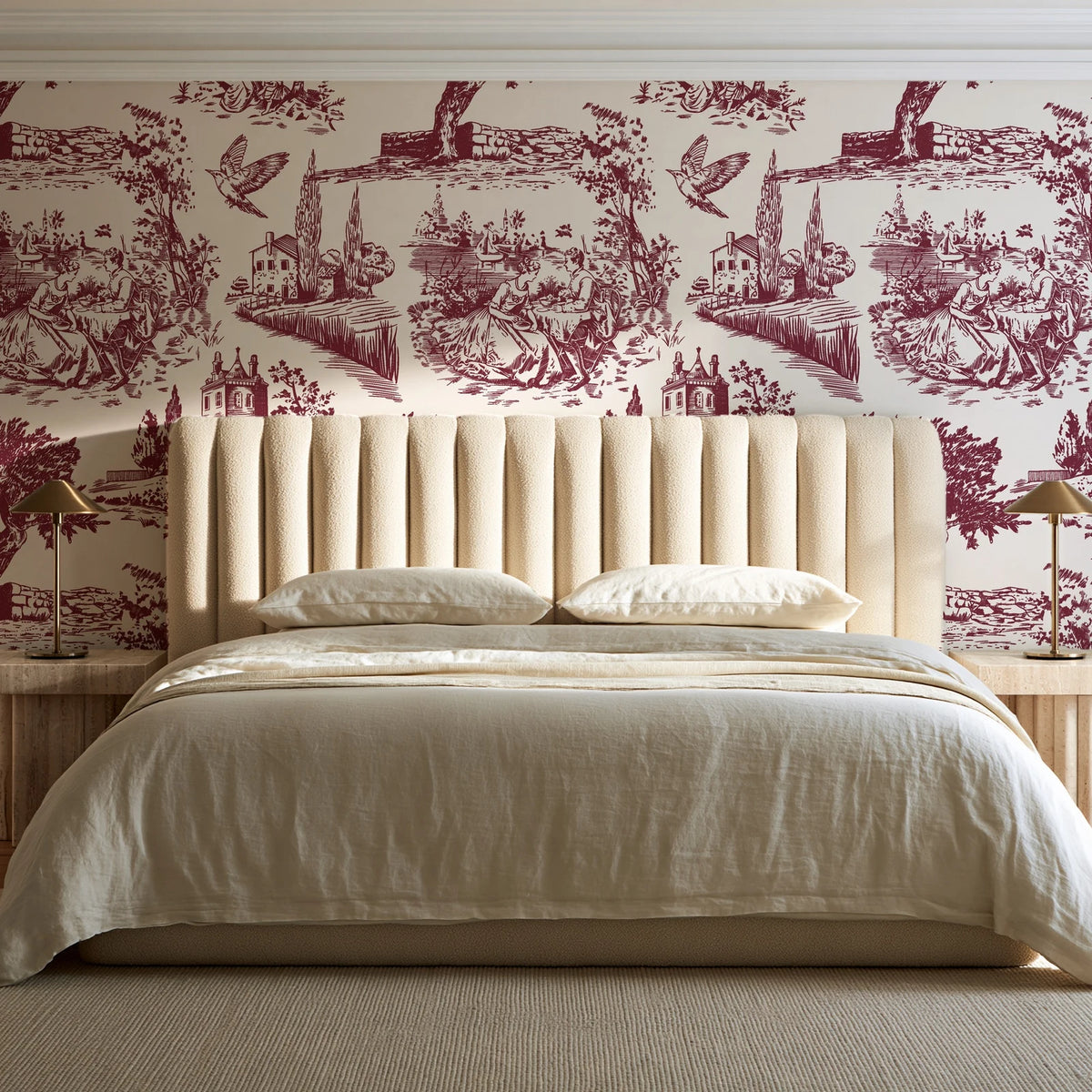 Arcadian Reverie Claret pastoral toile wallpaper behind a channel-tufted bed in a calm primary bedroom