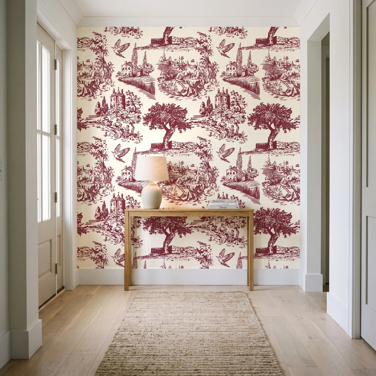 Arcadian Reverie Claret pastoral toile wallpaper behind a console table in a light entry hallway