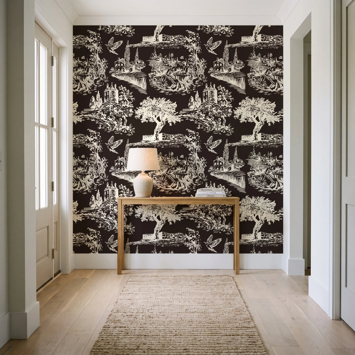 Arcadian Reverie Espresso pastoral toile wallpaper behind a console table in a light entry hallway