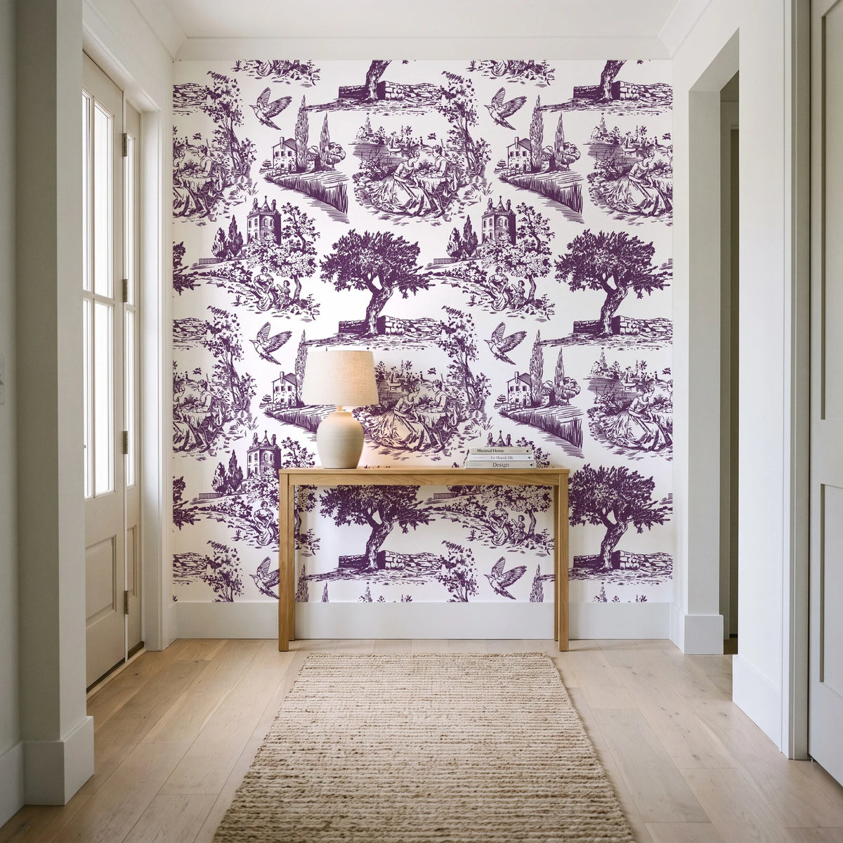 Arcadian Reverie Plum pastoral toile wallpaper behind a console table in a light entry hallway