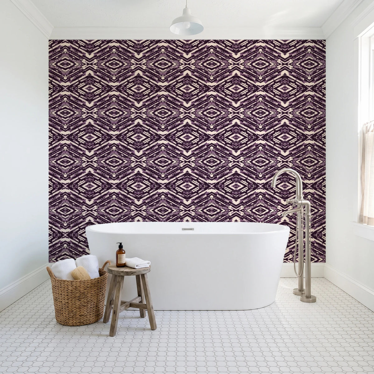 Arrows At Dawn Aubergine geometric diamond wallpaper behind a freestanding tub in a bright coastal bathroom