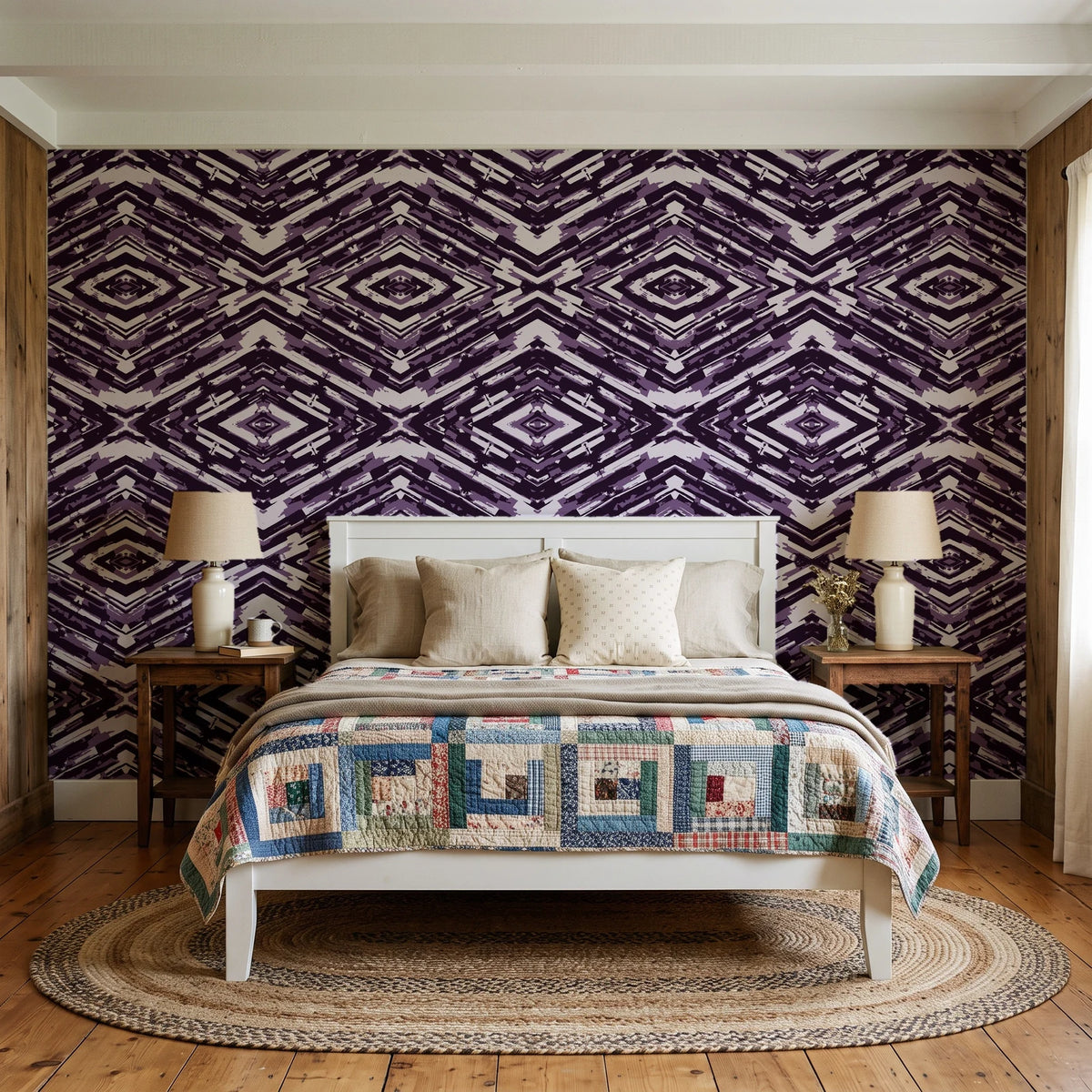 Arrows At Dawn Aubergine geometric diamond wallpaper behind a white cottage bed with a patchwork quilt in a cozy cottagecore bedroom