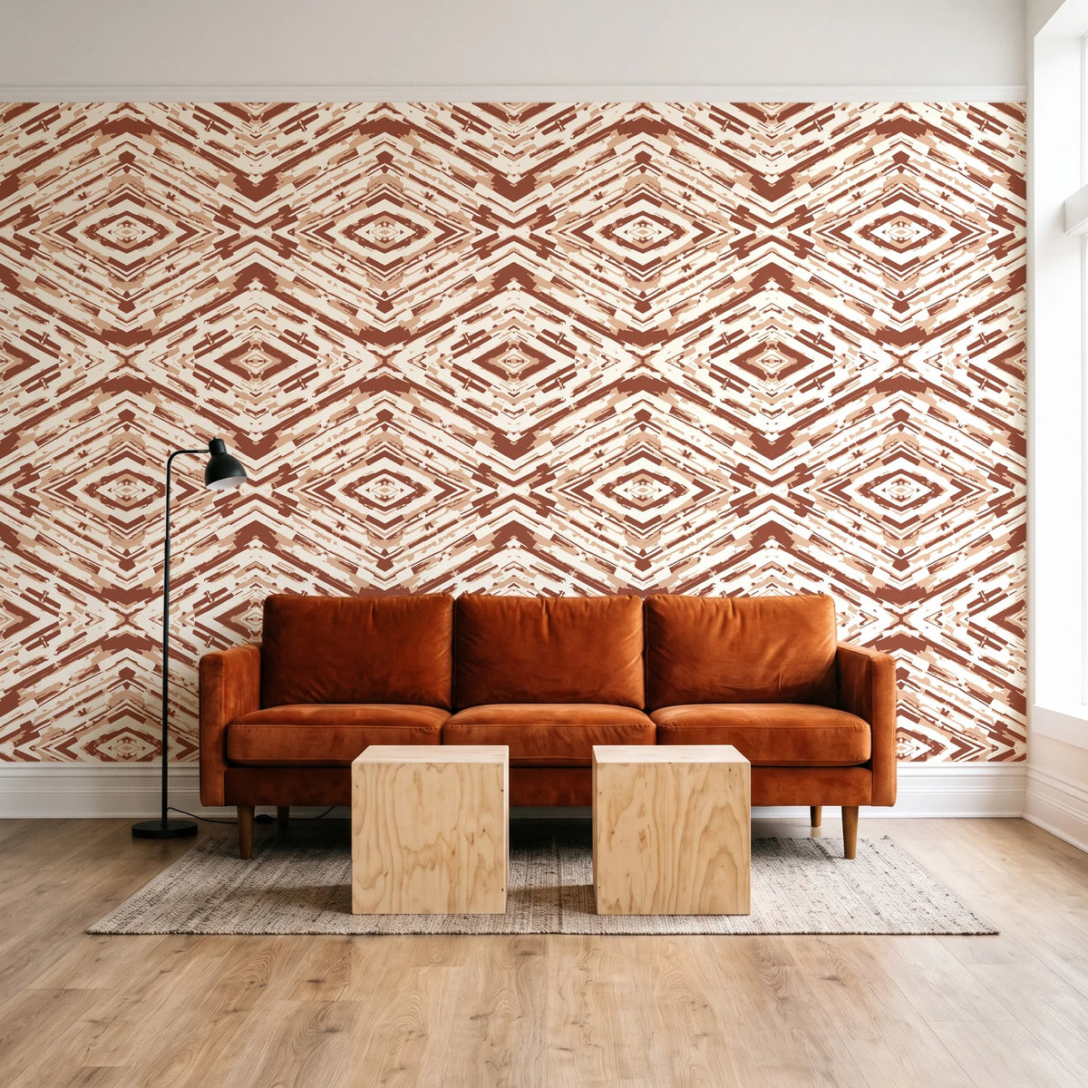 Arrows At Dawn Terracotta geometric diamond wallpaper behind a rust velvet sofa in a bright coworking lounge