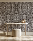 Aztec Quilt Espresso geometric tribal wallpaper on the wall of a grand entry foyer