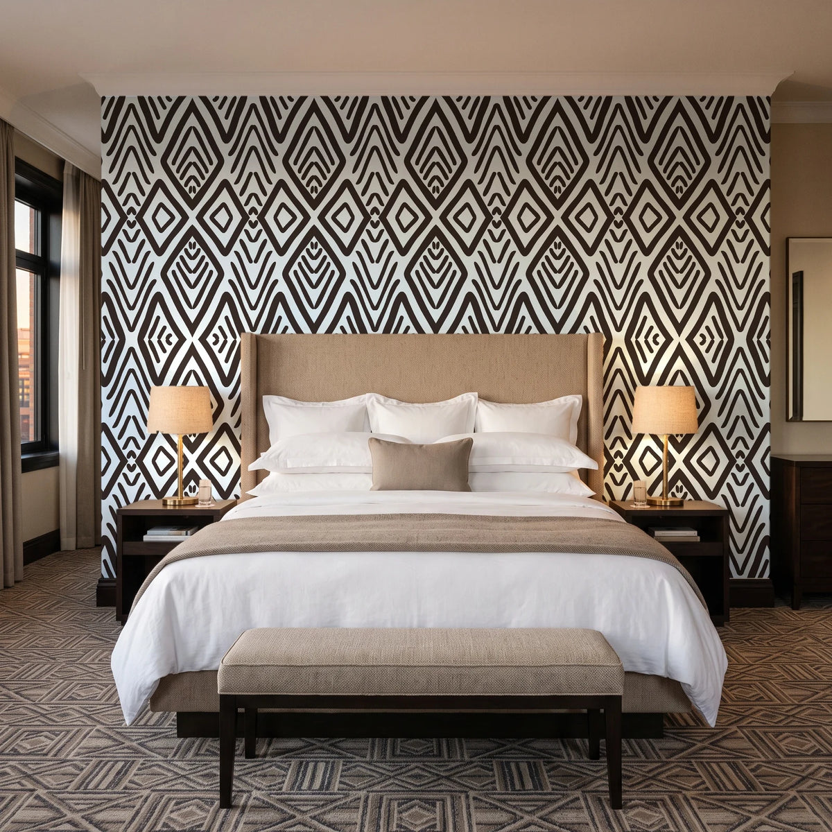 Aztec Quilt Espresso geometric tribal wallpaper behind the headboard of a king bed in a contemporary hotel guest room