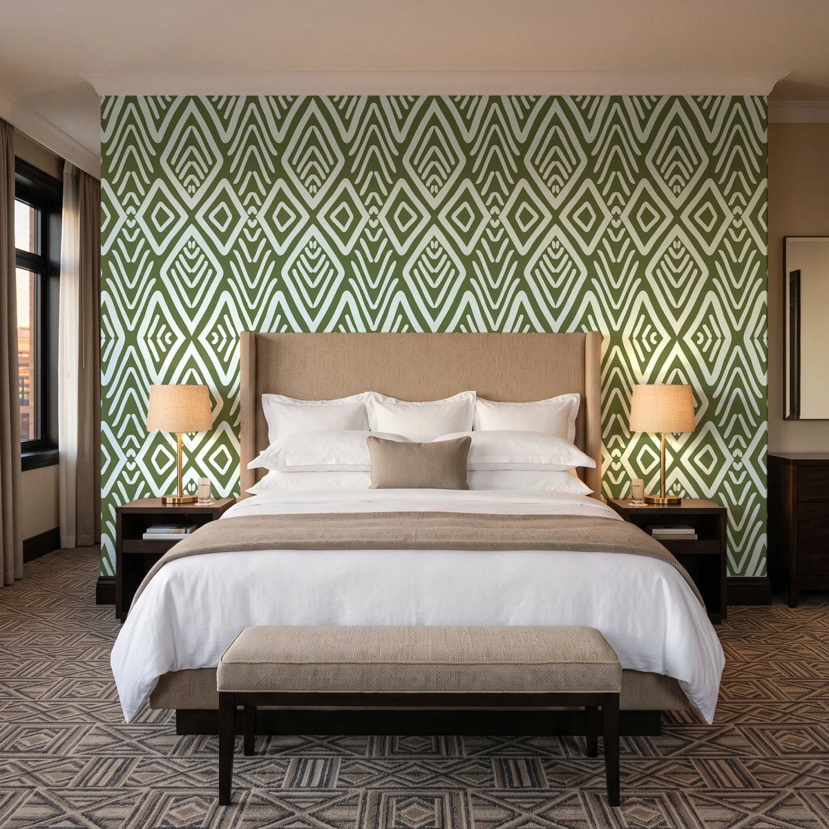 Aztec Quilt Olive geometric tribal wallpaper behind the headboard of a king bed in a contemporary hotel guest room