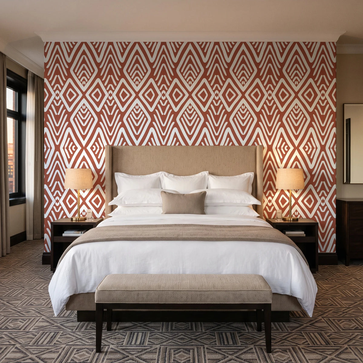 Aztec Quilt Terracotta geometric tribal wallpaper behind the headboard of a king bed in a contemporary hotel guest room