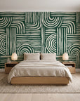 Bantu Lines Emerald brush geometric wallpaper behind a low platform bed in a serene Japandi bedroom