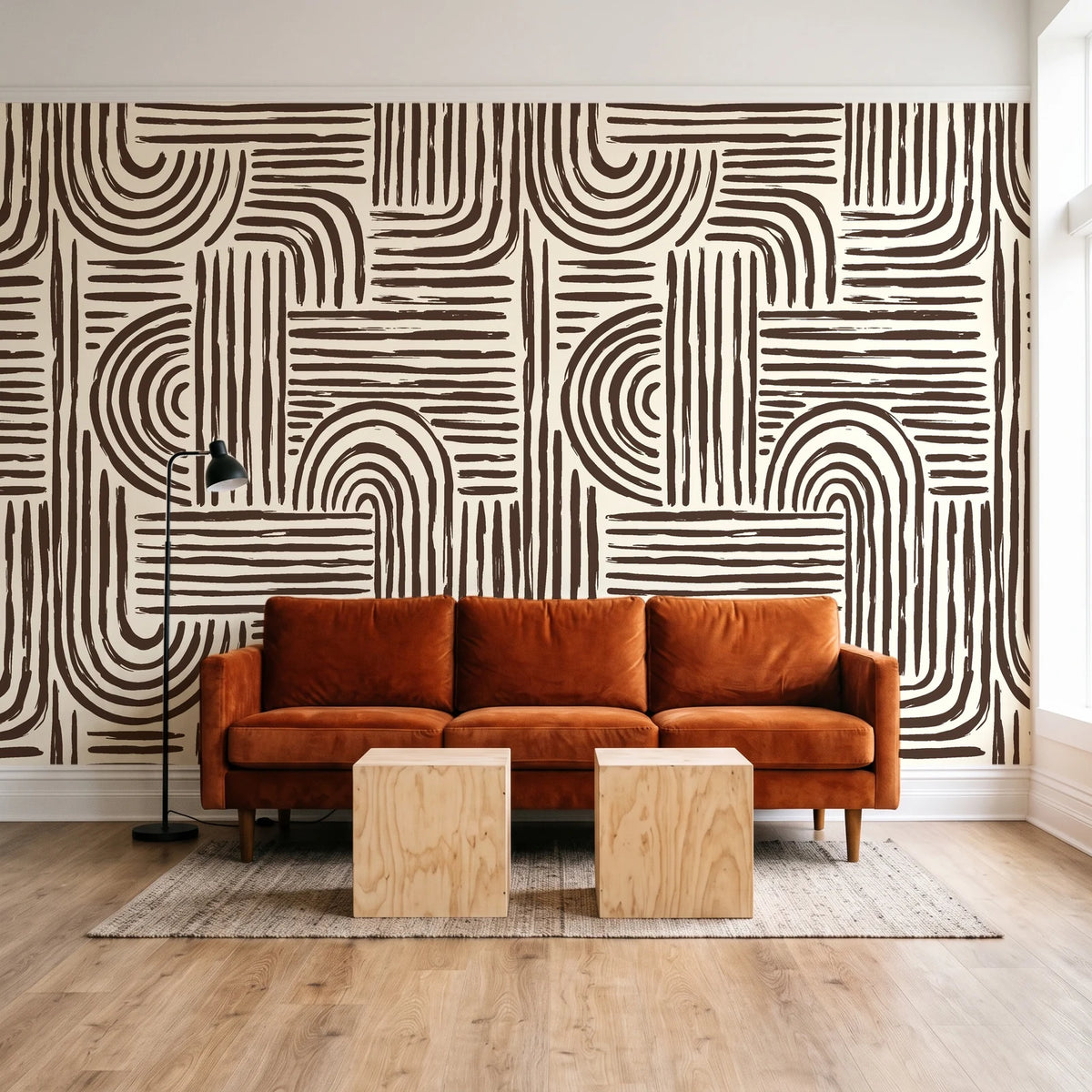 Bantu Lines Espresso brush geometric wallpaper behind a rust velvet sofa in a bright coworking lounge