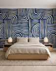 Bantu Lines Navy brush geometric wallpaper behind a low platform bed in a serene Japandi bedroom
