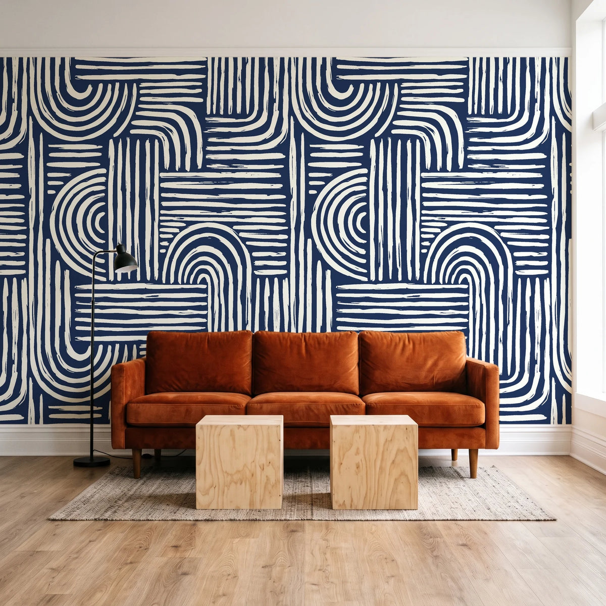Bantu Lines Navy brush geometric wallpaper behind a rust velvet sofa in a bright coworking lounge