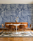 Bantu Lines Navy brush geometric wallpaper in a mid-century dining room with a teak sideboard and tulip table