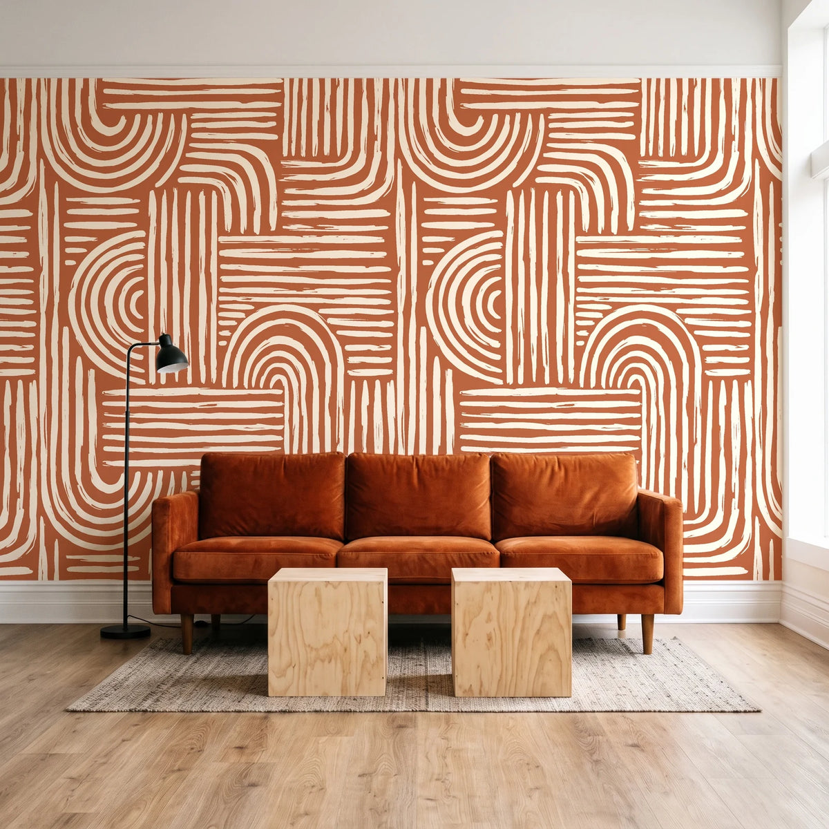 Bantu Lines Terracotta brush geometric wallpaper behind a rust velvet sofa in a bright coworking lounge