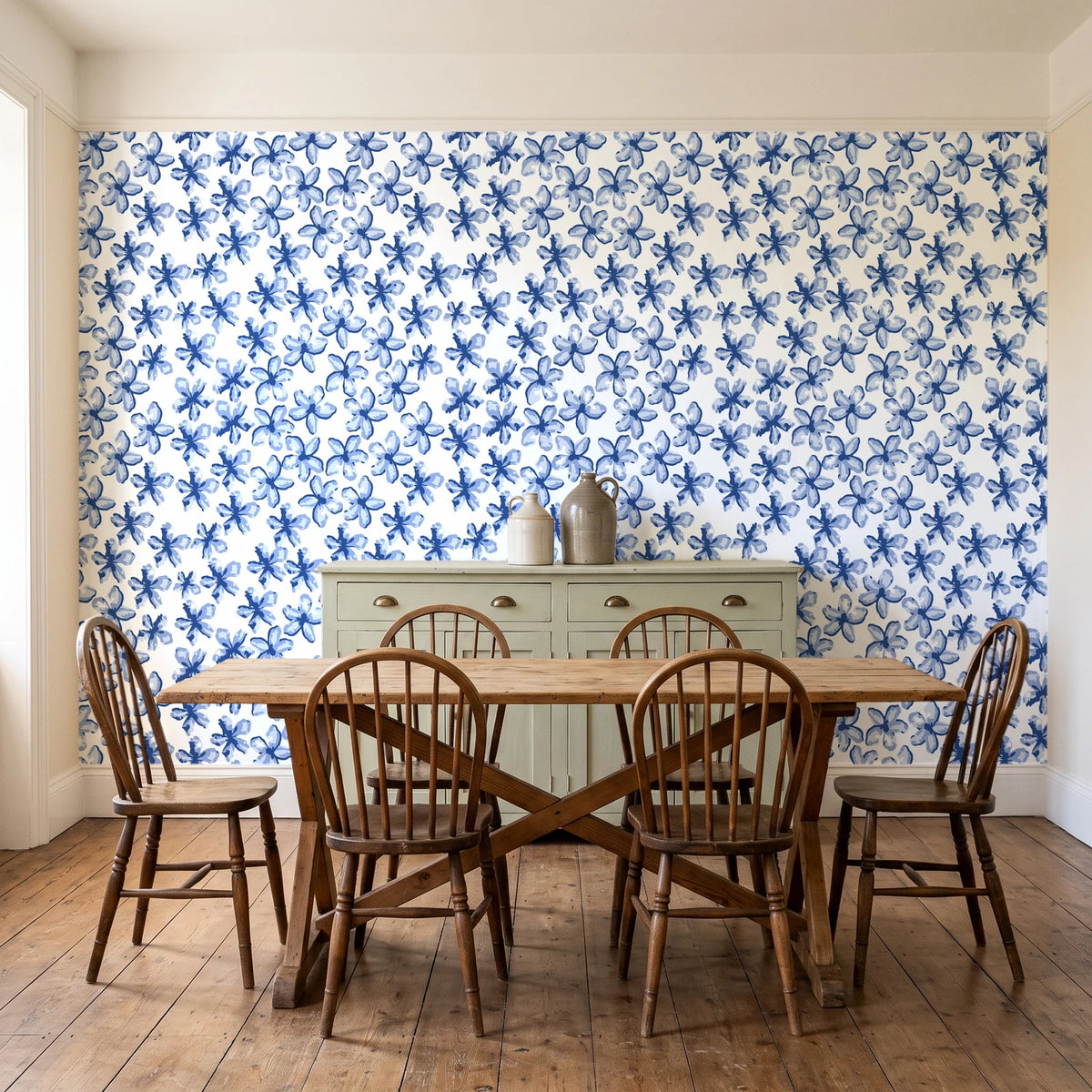 Blazing Petal Cobalt hibiscus floral wallpaper in a farmhouse dining room with a sage sideboard and rustic trestle table