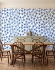 Blazing Petal Cobalt hibiscus floral wallpaper in a farmhouse dining room with a sage sideboard and rustic trestle table