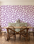 Blazing Petal Plum hibiscus floral wallpaper in a farmhouse dining room with a sage sideboard and rustic trestle table
