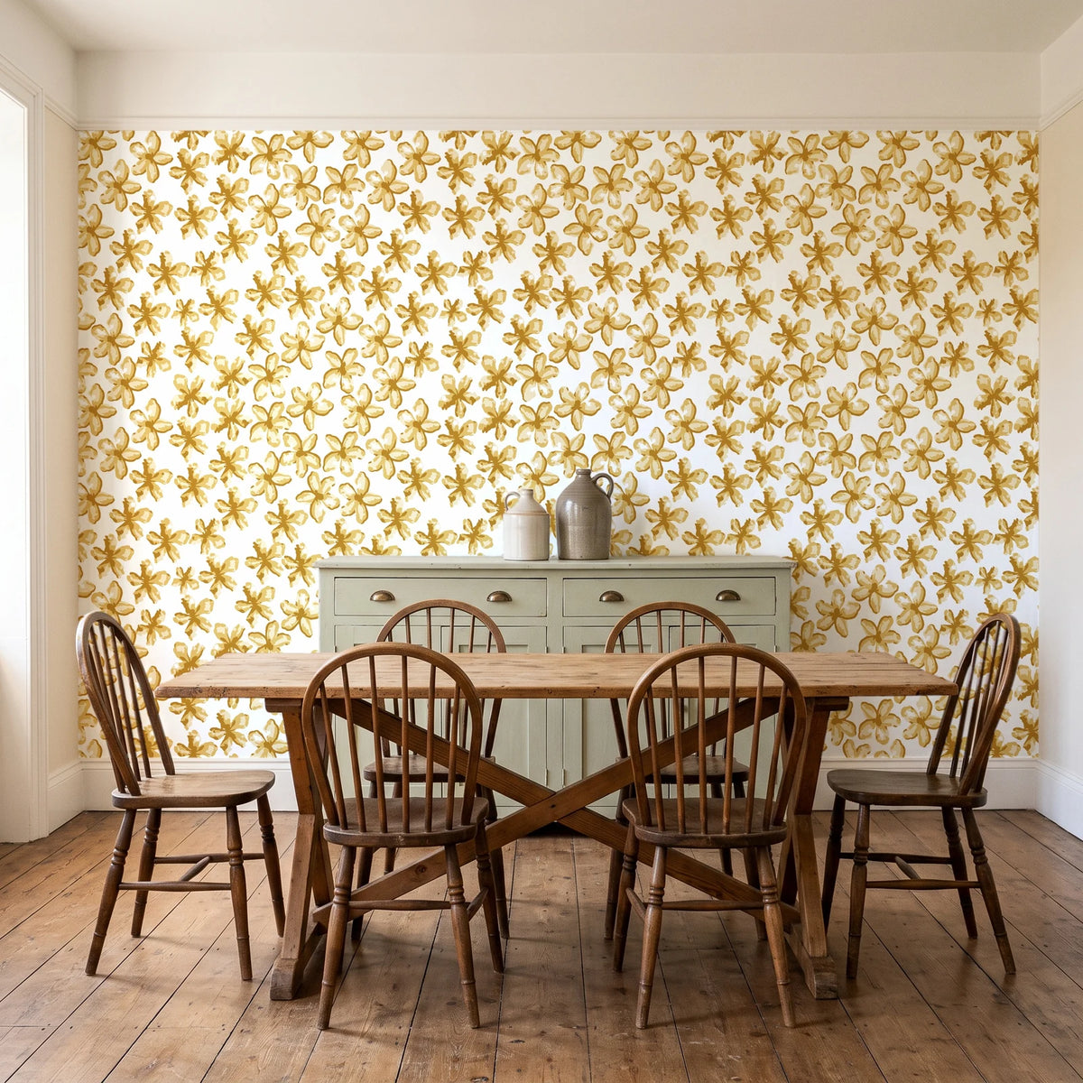 Blazing Petal Saffron hibiscus floral wallpaper in a farmhouse dining room with a sage sideboard and rustic trestle table