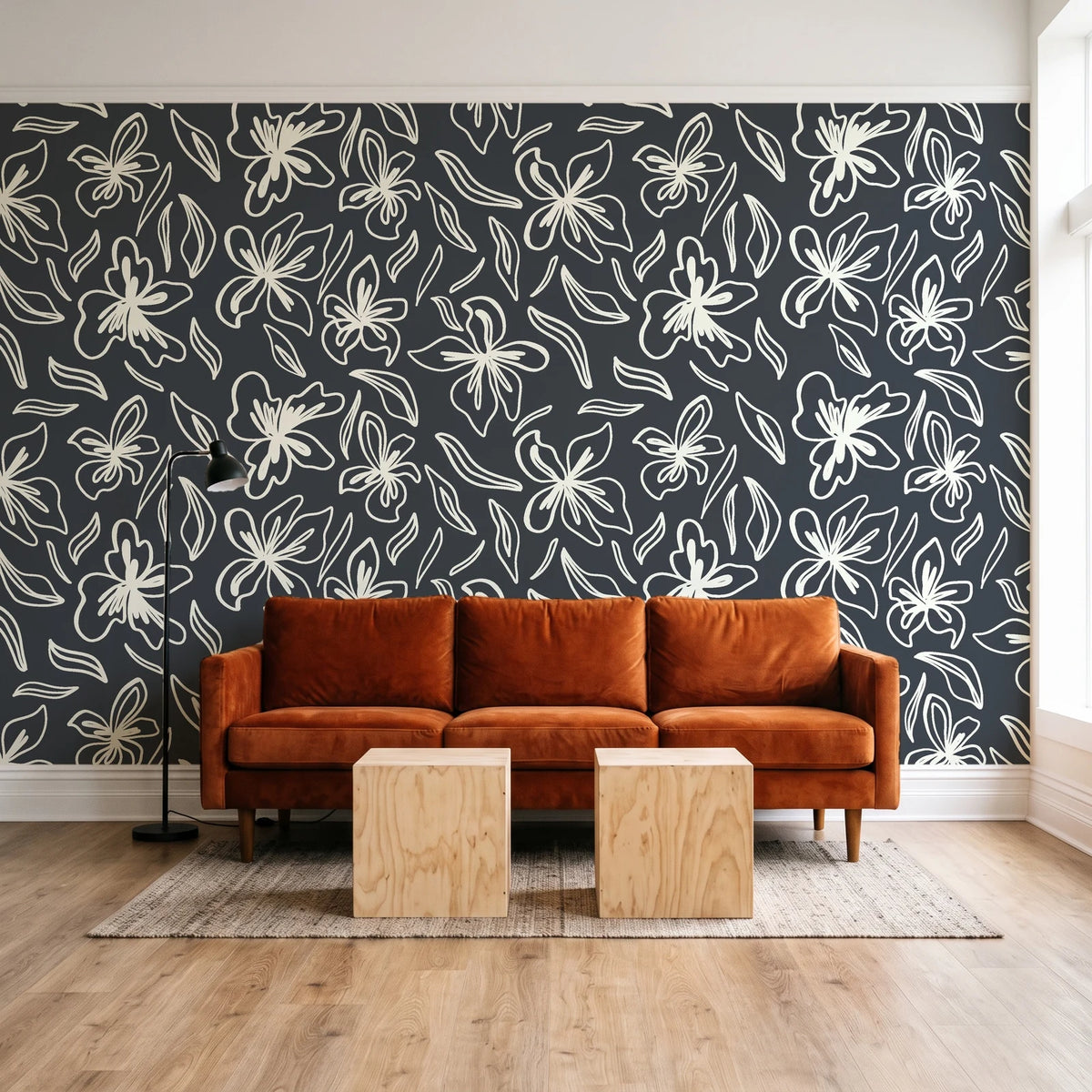 Blueprint Bloom Charcoal floral line wallpaper behind a rust velvet sofa in a bright coworking lounge