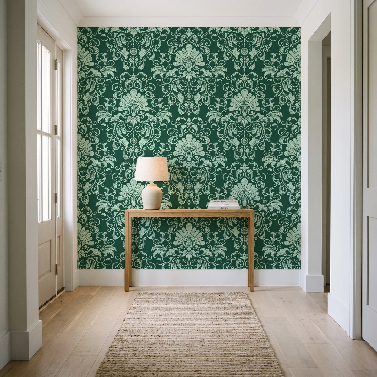 Blushed Whisper Emerald distressed damask wallpaper behind a console table in a light entry hallway