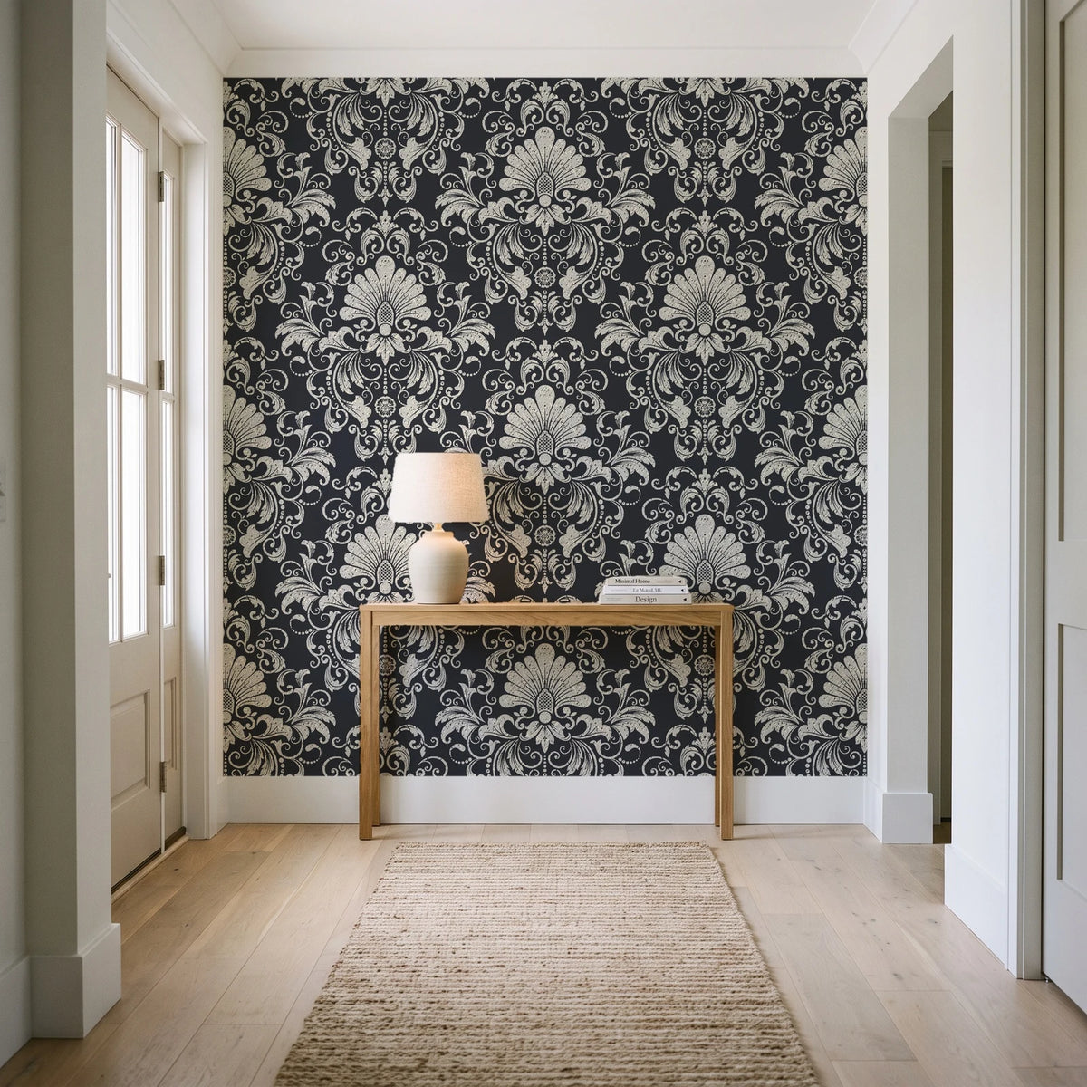 Blushed Whisper Graphite distressed damask wallpaper behind a console table in a light entry hallway