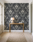 Blushed Whisper Graphite distressed damask wallpaper behind a console table in a light entry hallway