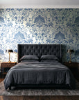 Blushed Whisper Linen distressed damask wallpaper behind a tufted headboard in a dark, moody bedroom