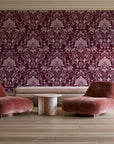 Blushed Whisper Oxblood distressed damask wallpaper in a boutique hotel sitting area