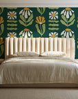 Bohemian Daisy Forest retro floral wallpaper behind a channel-tufted bed in a calm primary bedroom