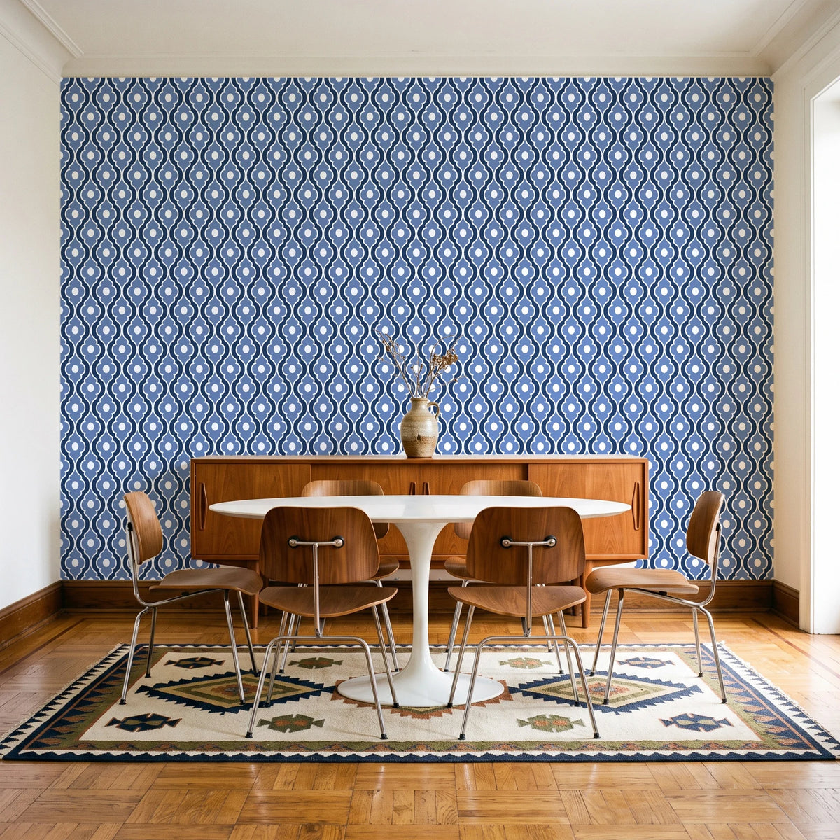 Butter Ogee Midnight ogee trellis wallpaper in a mid-century dining room with a teak sideboard and tulip table
