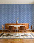 Butter Ogee Midnight ogee trellis wallpaper in a mid-century dining room with a teak sideboard and tulip table