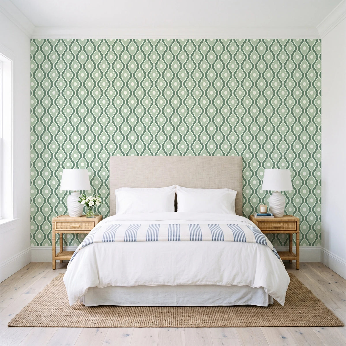 Butter Ogee Sage ogee trellis wallpaper behind a queen bed in a bright coastal bedroom